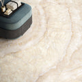 Interior floor setting featuring Lumen Precious Stone Ivory 60 × 120cm polished porcelain tiles, showcasing soft ivory and cream gemstone-inspired tones with delicate natural veining, layered crystal-like detailing, and a luxurious high-gloss finish.