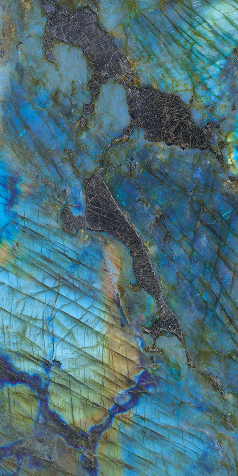 Single tile display of Lumen Precious Stone Labradorite 60 × 120cm polished porcelain tiles, featuring striking blue, teal, and charcoal gemstone-inspired tones with iridescent detailing, layered natural variation, and a luxurious high-gloss finish.