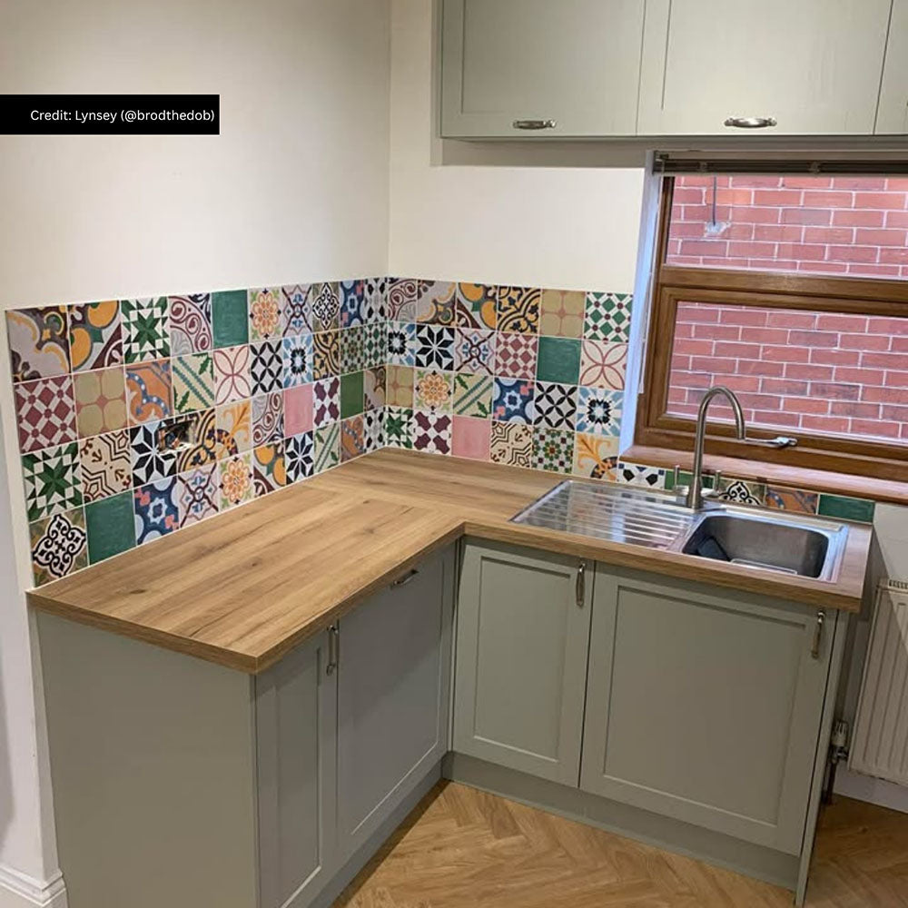 Kitchen splashback featuring Fayrouz Mini Patchwork Moroccan style tiles 15 × 15cm, combining a mix of intricate geometric and decorative patterns in rich, varied tones. Paired with shaker cabinetry and wood worktops for a warm, characterful finish.