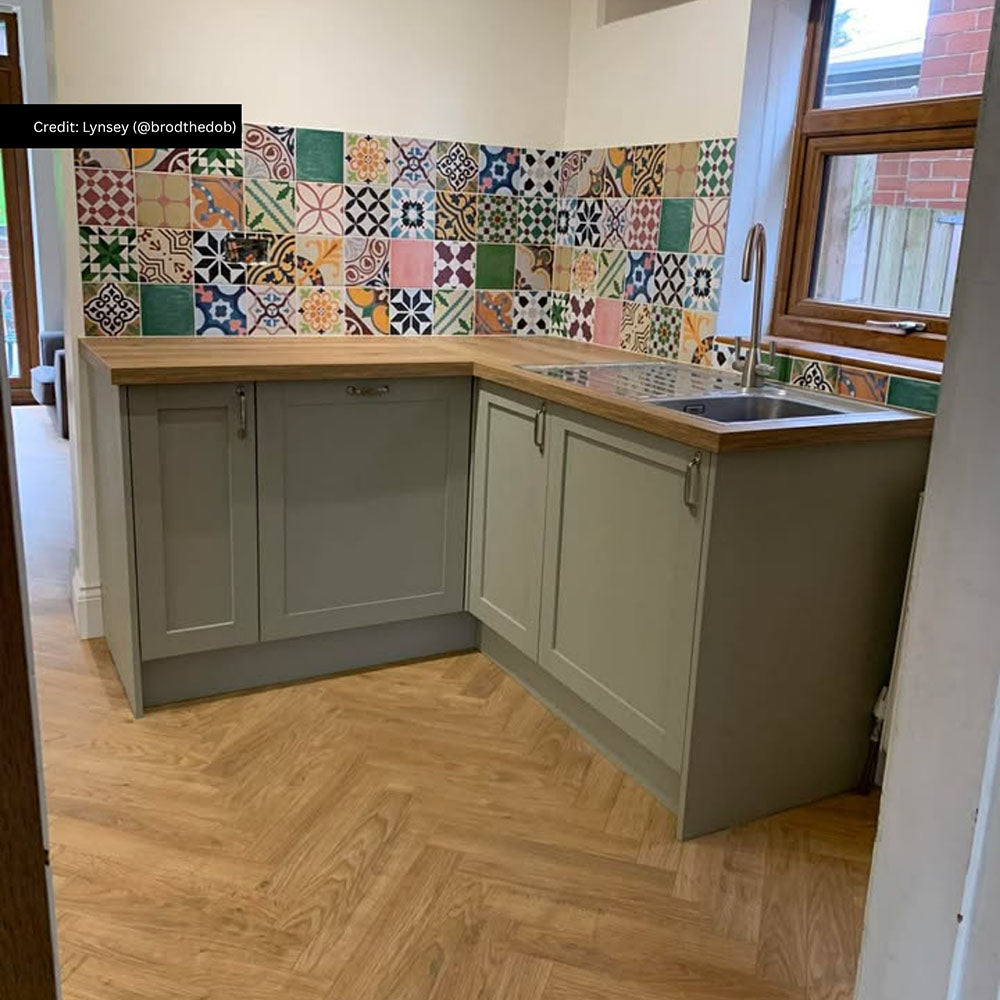 Kitchen splashback featuring Fayrouz Mini Patchwork Moroccan style tiles 15 × 15cm, combining a mix of intricate geometric and decorative patterns in rich, varied tones. Paired with shaker cabinetry and wood worktops for a warm, characterful finish.