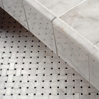 Bathroom detail featuring Fayrouz Black & White basketweave mosaic natural marble tiles with a honed finish, showcasing an intricate woven pattern with dark accents, installed alongside matching marble tiles for a cohesive, classic look.