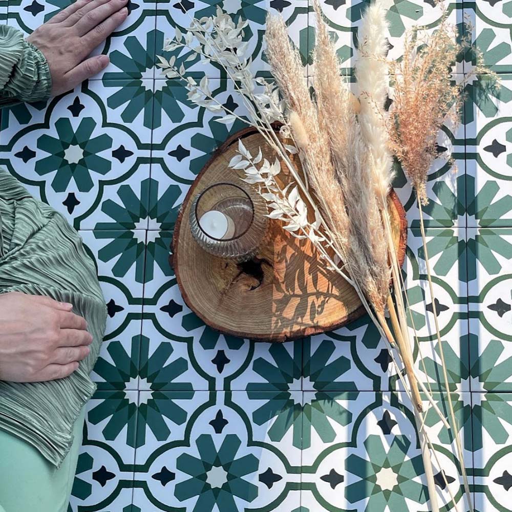 Clara Verde Victorian Moroccan-style porcelain floor tiles in a 20 × 20cm format, laid in a repeating pattern to highlight the bold green geometric design with decorative styling accents.