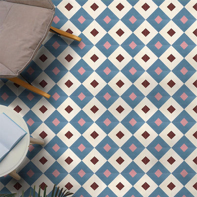 Interior floor featuring Cuba Guazzatto Moroccan-style porcelain tiles in a 20×20cm square format, arranged in a repeating geometric diamond pattern in soft blue, white, pink and burgundy tones, styled with contemporary furniture to highlight the tile’s bold yet balanced design.