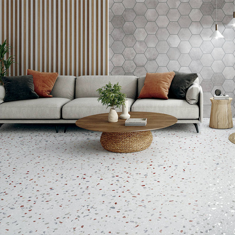 Living space featuring Gelato Colours 66x66cm terrazzo-style porcelain floor tiles, showcasing a soft neutral base with subtle multicoloured terrazzo flecks, styled with contemporary furniture, natural textures and large windows for a bright, modern interior.