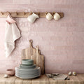 Kitchen featuring Nomad Rose brick wall tiles in a 6 × 24.6cm format, laid horizontally to create a soft pink, industrial-inspired splashback.