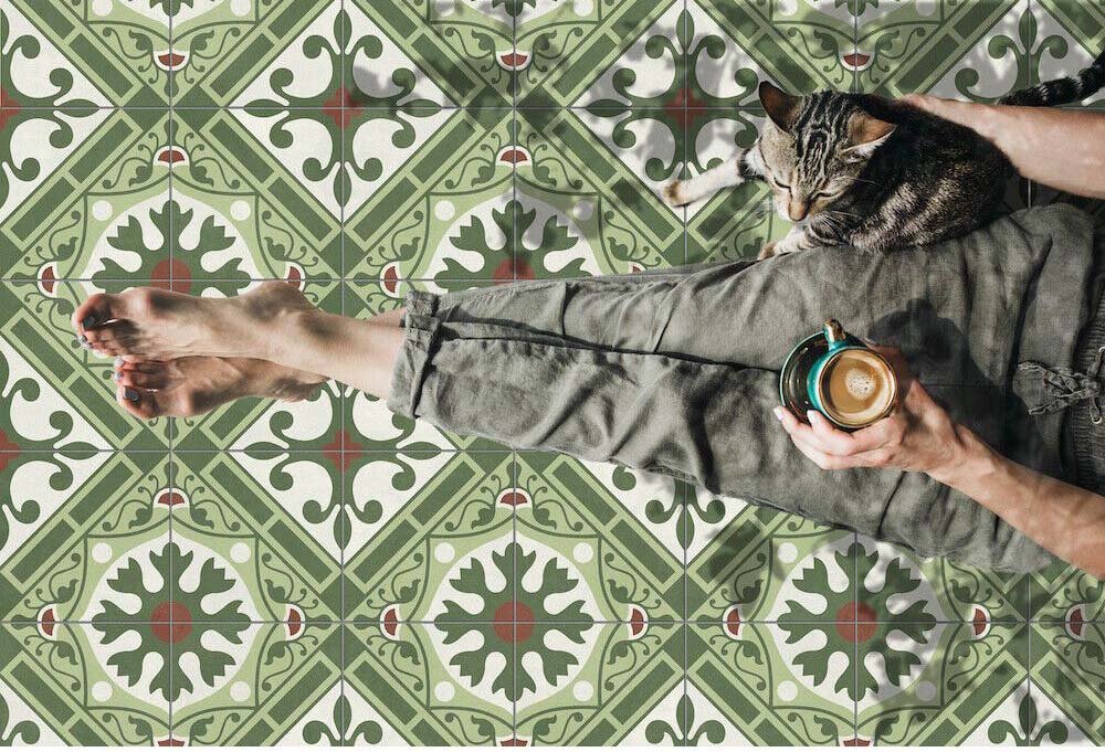 Close-up of Mediterraneo Corfu 2cm patterned outdoor slabs 50 × 100cm, featuring a decorative Mediterranean-inspired pattern in green, cream, and terracotta tones with a vintage-style finish and geometric detailing.