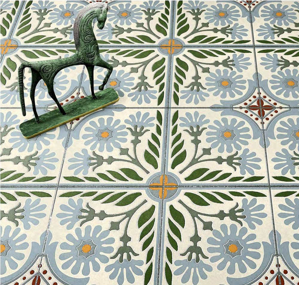 Close-up of Mediterraneo Olbia 2cm patterned outdoor slabs 50 × 100cm, featuring a faded Mediterranean-inspired floral design in soft green, blue, and terracotta tones with a decorative vintage-style finish.