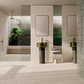 Contemporary bathroom featuring Melange Light Cosmo Stone wall and floor tiles 60 × 120cm, showcasing soft ivory stone-effect tones with subtle aggregate detailing, paired with green glass basins, fluted glass panels, and minimalist fittings.