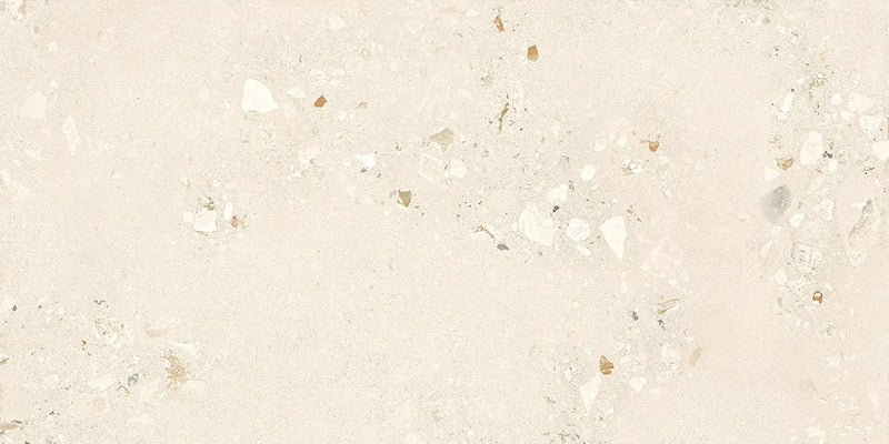 Close-up of Melange Light Cosmo Stone wall and floor tiles 60 × 120cm, featuring soft ivory stone-effect tones with subtle aggregate detailing, delicate texture, and a refined contemporary matt finish.