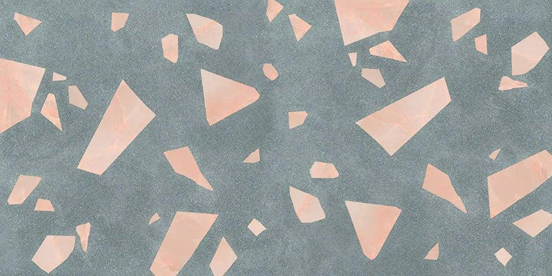 Close-up of Melody ROCK Terrazzo Green 60 × 120cm terrazzo-effect porcelain tiles, featuring oversized blush pink marble-style fragments scattered across a deep green-grey base for a bold contemporary statement finish.