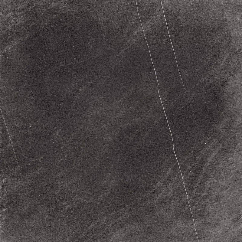 Product display of Monzo Stone Nite 60x60cm dark stone-effect porcelain tiles in deep charcoal tones, featuring dramatic tonal variation, textured detailing and natural stone-inspired movement across the surface.