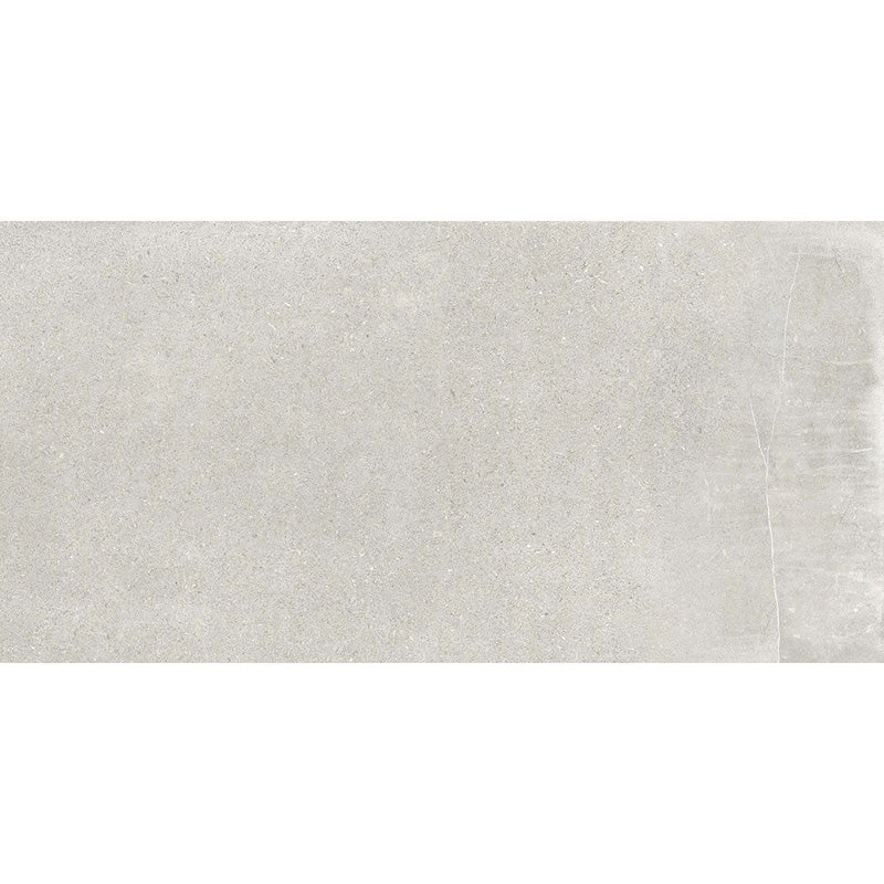 Product display of Monzo Stone Silver 30x60cm stone-effect porcelain tiles in soft silver-grey tones, featuring subtle texture and tonal variation with a natural stone-inspired finish.