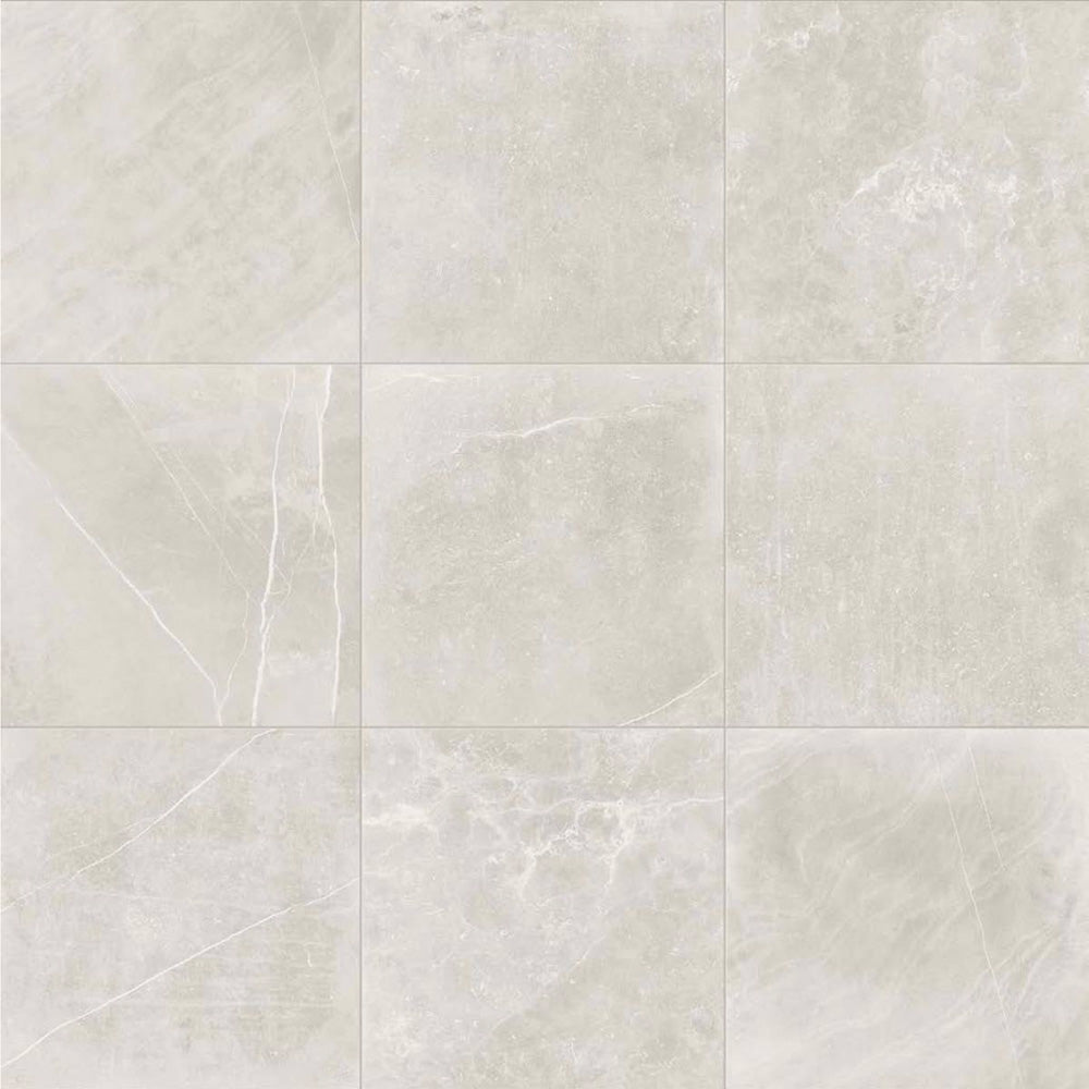 Product display of Monzo Stone Silver 60x60cm stone-effect porcelain tiles in soft silver-grey tones, featuring delicate veining, subtle texture, and natural tonal variation with a contemporary stone-inspired finish.