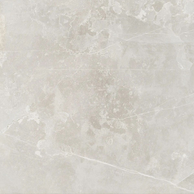 Product display of Monzo Stone Silver 60x60cm stone-effect porcelain tiles in soft silver-grey tones, featuring delicate veining, subtle texture, and natural tonal variation with a contemporary stone-inspired finish.