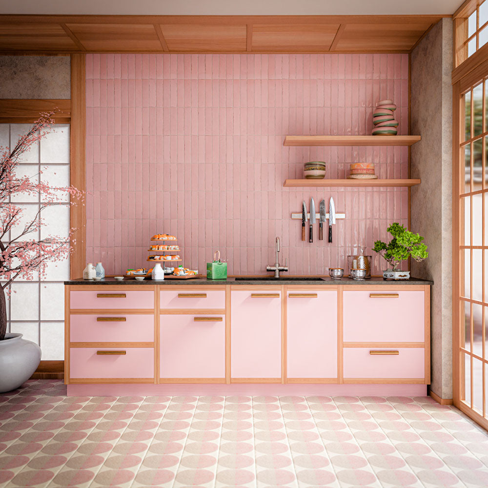 Interior featuring Nomad Rose brick-effect wall tiles, showcasing soft blush pink tones and a subtle handcrafted-inspired finish. Laid vertically across the full splashback, the tiles create height and texture while complementing the warm timber detailing and pastel cabinetry. The combination of pink hues, natural wood accents and contemporary styling creates a playful yet refined space that feels welcoming, modern and effortlessly on trend. Perfect for adding warmth, colour and personality to kitchens, bat
