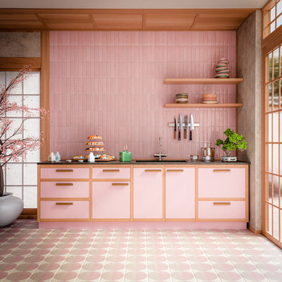 Interior featuring Nomad Rose brick-effect wall tiles, showcasing soft blush pink tones and a subtle handcrafted-inspired finish. Laid vertically across the full splashback, the tiles create height and texture while complementing the warm timber detailing and pastel cabinetry. The combination of pink hues, natural wood accents and contemporary styling creates a playful yet refined space that feels welcoming, modern and effortlessly on trend. Perfect for adding warmth, colour and personality to kitchens, bat