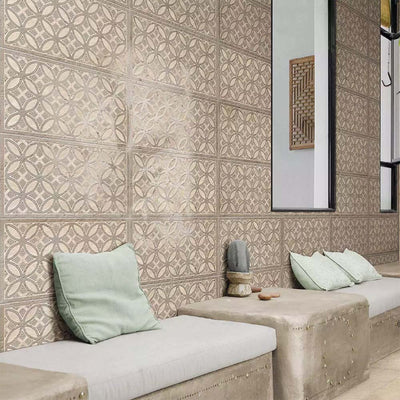 Bathroom featuring Ourika Sandy Beach Moroccan style decorative porcelain wall tiles, showcasing an intricate geometric floral pattern in soft sand, taupe and warm beige tones with a gently aged finish, paired with built-in concrete seating, pale green cushions, black framed mirrors and natural textures for a calm, contemporary Moroccan-inspired interior.