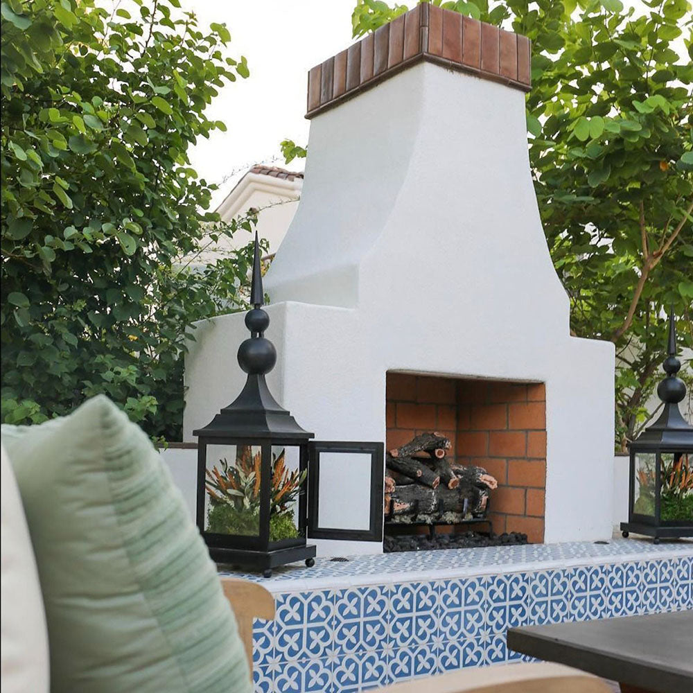 Ivy Blue Victorian Moroccan style 20x20cm patterned tiles, used on an outdoor fireplace surround to create a decorative blue and white geometric feature.