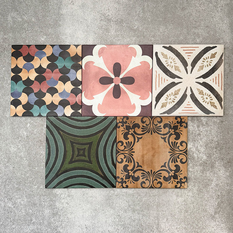Cuba Patchwork Moroccan-style porcelain tiles in a 20×20cm square format, arranged in a mixed patchwork layout featuring a variety of geometric, floral and traditional motifs in earthy, green, blue and terracotta tones, highlighting the tile’s eclectic, encaustic-style design and rich visual texture.