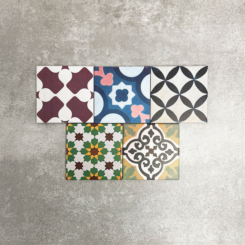 Fayrouz Mini Patchwork 15×15cm Moroccan-style porcelain tiles displayed as a mixed patchwork layout, showcasing a vibrant collection of geometric and floral designs in green, blue, pink, mustard, terracotta and neutral tones.