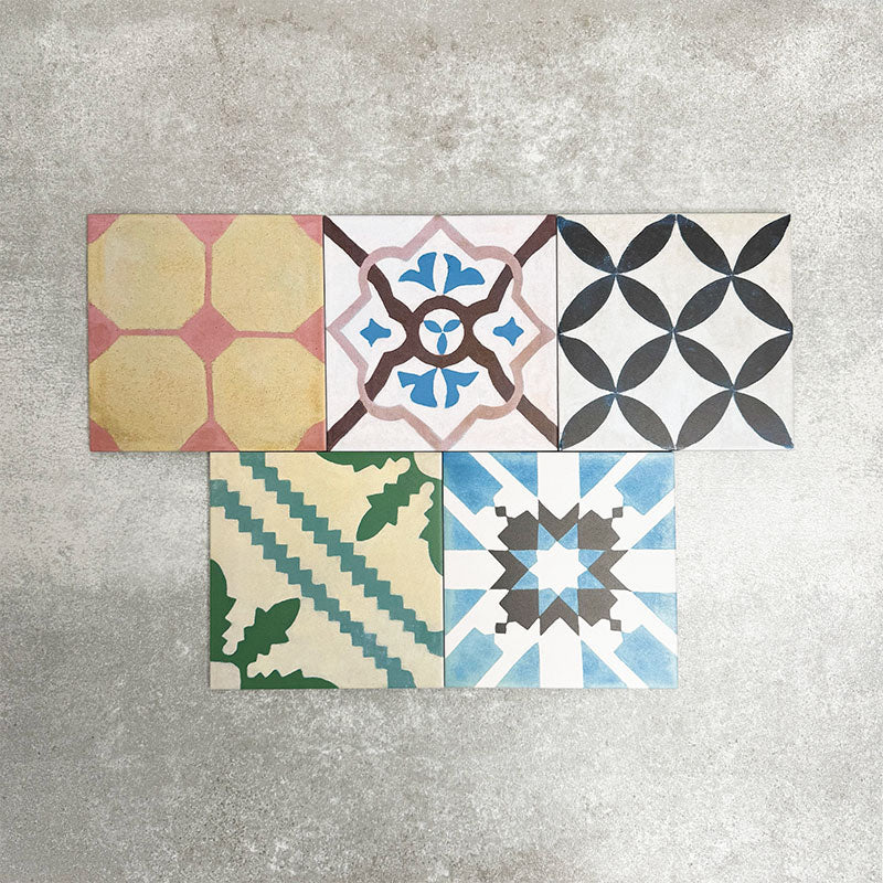 Fayrouz Patchwork 20×20cm Moroccan-style porcelain tiles arranged in a colourful patchwork mix of geometric and floral patterns, featuring rich tones of blue, green, pink and warm neutrals.