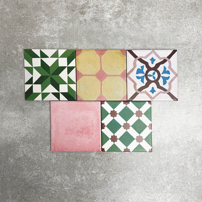 Fayrouz Mini Patchwork 15×15cm Moroccan-style porcelain tiles displayed as a mixed patchwork layout, showcasing a vibrant collection of geometric and floral designs in green, blue, pink, mustard, terracotta and neutral tones.