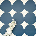 Pebbles Reversed Blue 20x20cm porcelain Moroccan-style tiles featuring bold organic blue shapes on a soft white background, designed to create playful statement walls and contemporary patterned interiors.