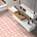Bathroom featuring Pebbles Reversed Pink 20x20cm porcelain Moroccan-style floor tiles with soft blush abstract patterning, paired with wood accents, floating white cabinetry, and minimalist contemporary styling.