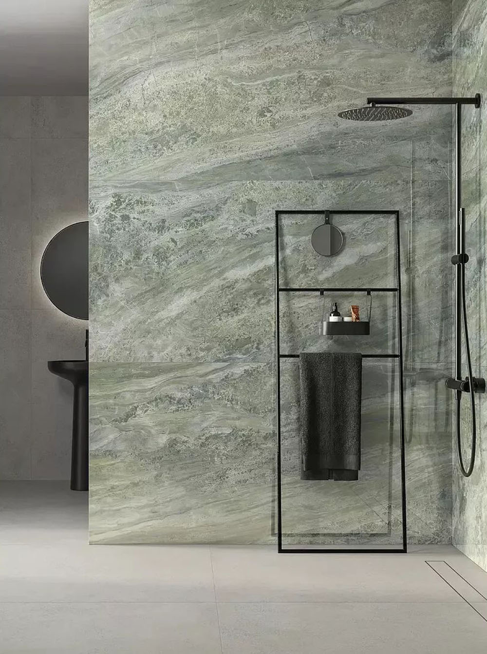 Bathroom featuring Petra Verde Green stone marble effect porcelain wall tiles in a 30cm x 60cm format, showcasing flowing green, sage and soft grey veining inspired by natural stone, paired with a walk-in shower, black framed shower screen, matte black brassware and minimalist fittings for a contemporary spa-inspired bathroom.