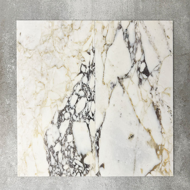Close-up of Fayrouz Picasso natural marble tiles in a honed finish, 30.5x61cm format, showcasing a soft white base with warm beige undertones and distinctive veining, creating a refined and elegant look for wall and floor applications.