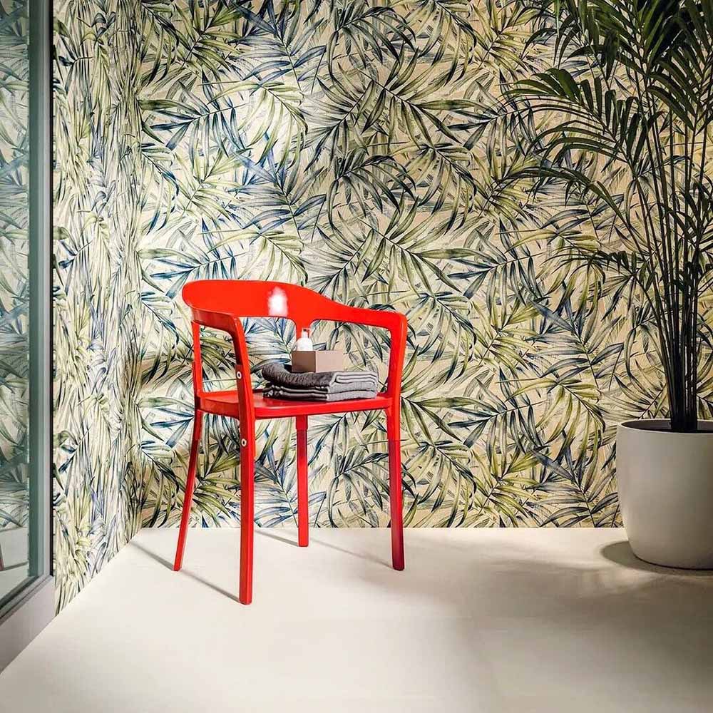 Bathroom featuring Plant Life Light Decor 60x120cm botanical-style wall tiles, showcasing a soft tropical leaf design in green, blue and beige tones, paired with a bold red chair, large indoor plant and minimalist décor.