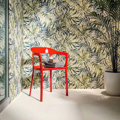 Bathroom featuring Plant Life Light Decor 60x120cm botanical-style wall tiles, showcasing a soft tropical leaf design in green, blue and beige tones, paired with a bold red chair, large indoor plant and minimalist décor.