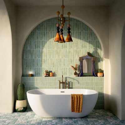 Bathroom featuring Pottery Decor Agave Green 12.5x25cm wall tiles, styled within an arched alcove around a freestanding bath with brass fixtures, striped tile detailing, and soft Mediterranean-inspired tones.