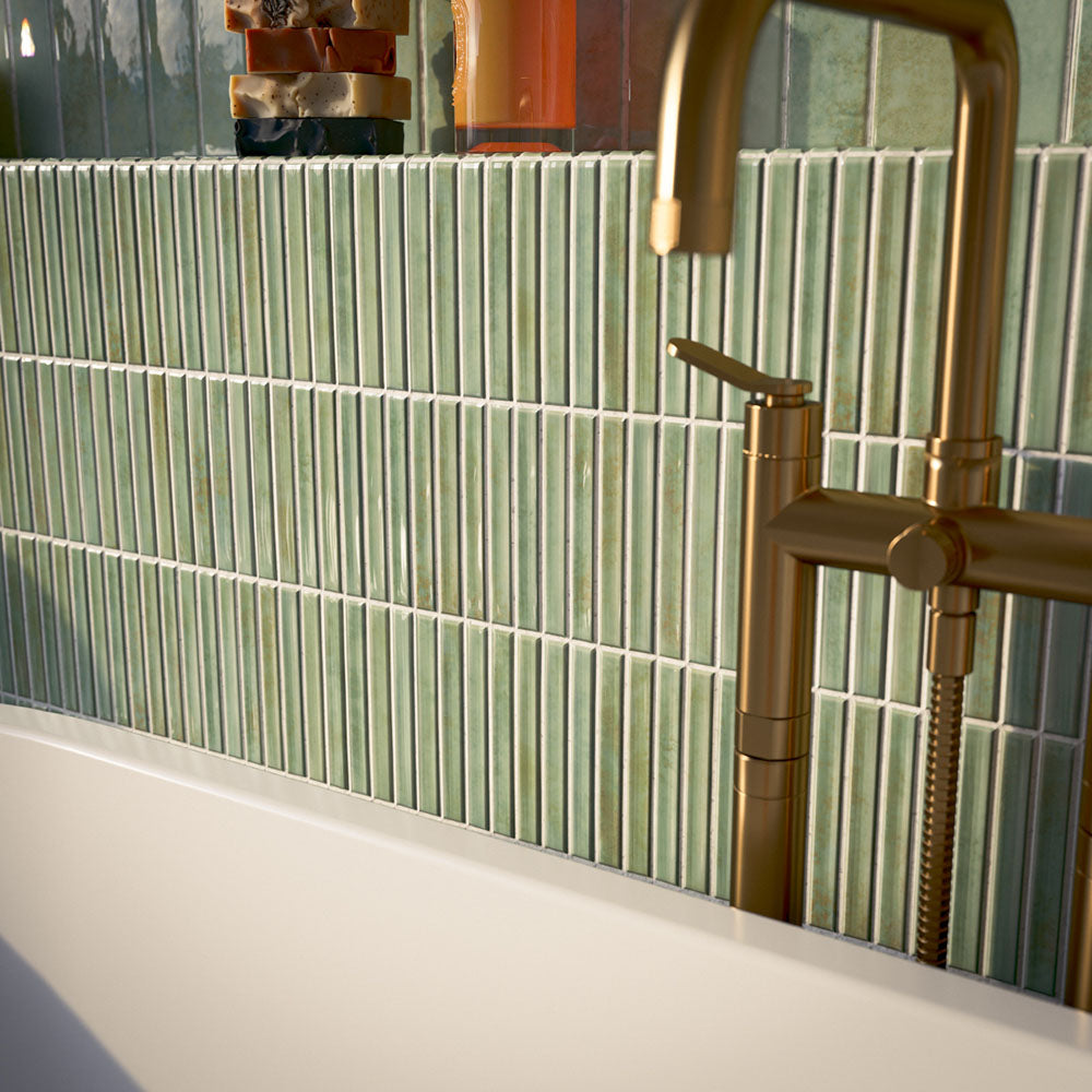Bathroom featuring Pottery Decor Agave Green 12.5x25cm wall tiles, styled within an arched alcove around a freestanding bath with brass fixtures, striped tile detailing, and soft Mediterranean-inspired tones.
