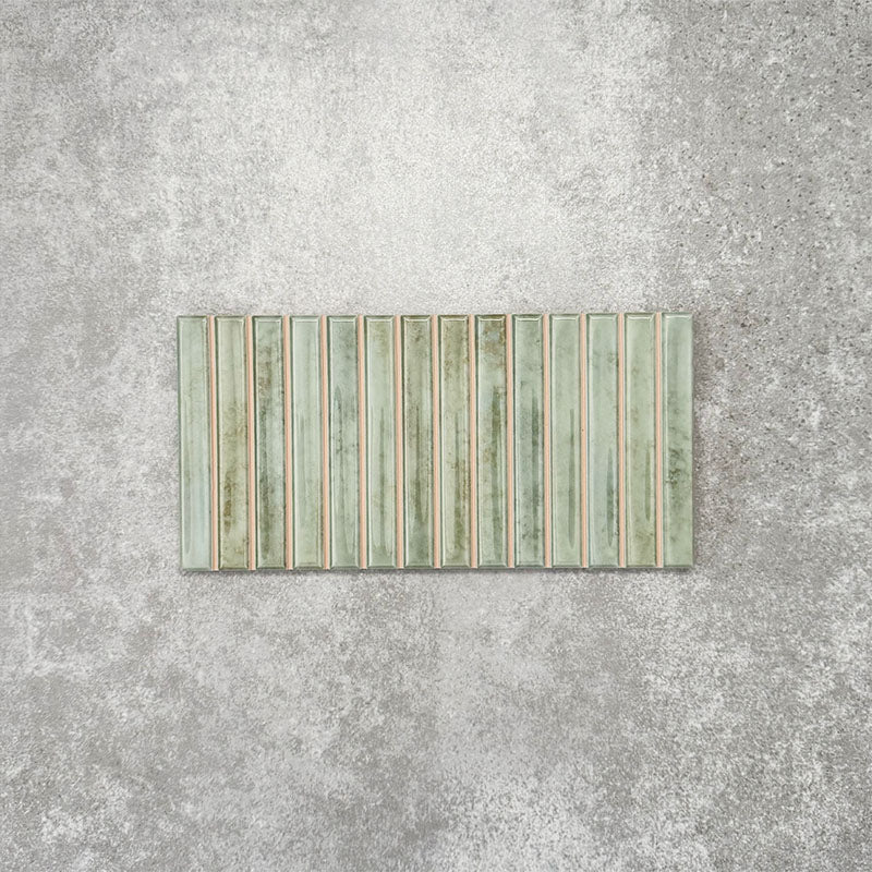 Product display of Pottery Decor Agave Green 12.5x25cm ceramic wall tiles in soft green tones, featuring a linear fluted design, handcrafted glossy finish and subtle tonal variation for textured contemporary interiors.