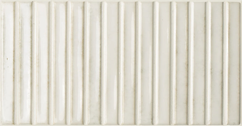 Product display of Pottery Decor Blanco 12.5x25cm ceramic wall tiles in soft white tones, featuring a linear fluted design, handcrafted glossy finish and subtle tonal variation for textured contemporary interiors.