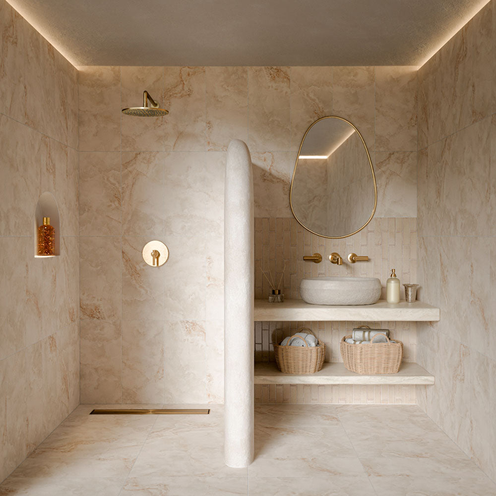 Contemporary bathroom featuring Puzzle Cream rectified porcelain brick tiles in 5cm x 20cm as a feature splashback behind a floating vanity. Warm cream wall tiles complement large marble effect porcelain tiles, creating a calm, luxurious spa-inspired bathroom with brass fixtures.