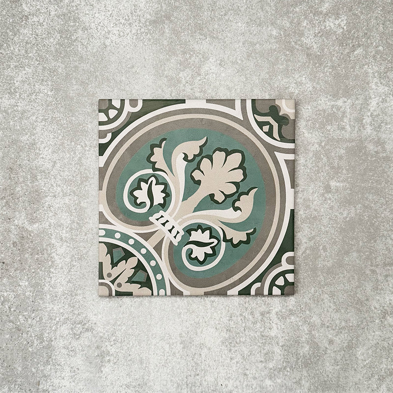 Single London Streets Regent Street 20x20cm Victorian Moroccan style porcelain tile displayed in a product setting, featuring a decorative floral-inspired geometric pattern in green, sage and cream tones inspired by traditional Victorian style floor tiles.