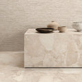 Interior featuring Riad Avorio Sassi Terrazzo Stone 60x60cm stone-effect wall and floor tiles, showcasing warm ivory and beige tones with natural stone-inspired detailing, styled with matching tiled cabinetry and light wood shelving for a contemporary finish.