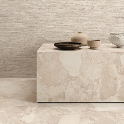 Interior featuring Riad Avorio Sassi Terrazzo Stone 60x60cm stone-effect wall and floor tiles, showcasing warm ivory and beige tones with natural stone-inspired detailing, styled with matching tiled cabinetry and light wood shelving for a contemporary finish.