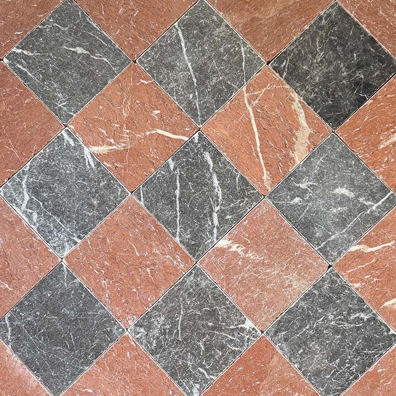 Chequerboard layout featuring Fayrouz Rosso 15.2x15.2cm natural marble tiles with a tumbled finish, paired with black marble tiles, installed diagonally to create a bold, high-contrast floor with rich natural veining.