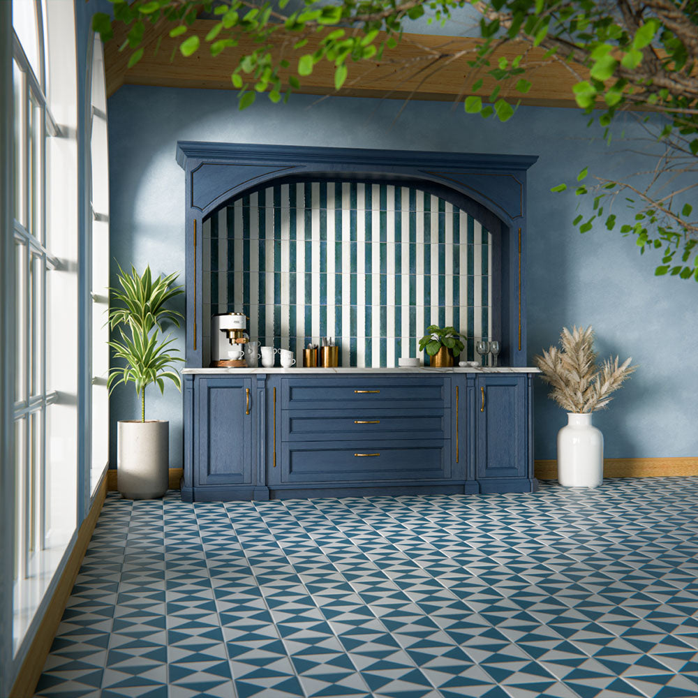 Kitchen interior featuring Allegra Blue 6x25cm gloss brick tiles, installed vertically within a statement alcove, showcasing rich blue tones with a reflective glazed finish, styled with deep blue cabinetry, brass accents, and a marble-effect worktop for a bold yet elegant design.
