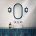 Bathroom interior featuring Foundry Bricks Arctic White 6.5x20cm ceramic wall tiles in a horizontal layout, styled with a blue tiled vanity, countertop basin and brushed metal fixtures.
