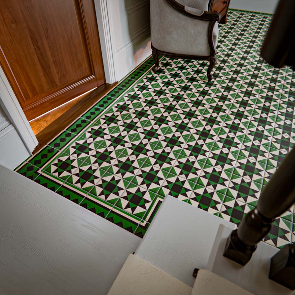 Greenbrook Manor side/border 20cm x 20cm porcelain tiles installed in a hallway, featuring a green, black and white Victorian-style geometric border framing the patterned floor tiles near a doorway.
