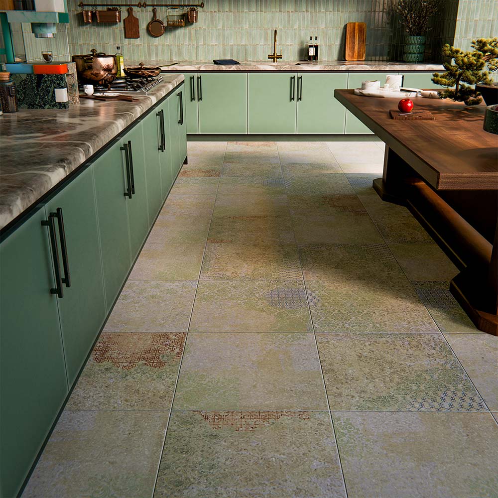 Boho Ocean Blend 60x60cm patterned porcelain floor tiles styled in a contemporary green kitchen setting. The large-format design features a subtle, multi-tonal decorative pattern that blends soft sage, muted blue and warm neutral tones, adding gentle movement underfoot without overpowering the space. Paired with sage cabinetry, warm wood accents and brass details, the patterned floor creates a cohesive, design-led finish ideal for modern kitchen interiors.