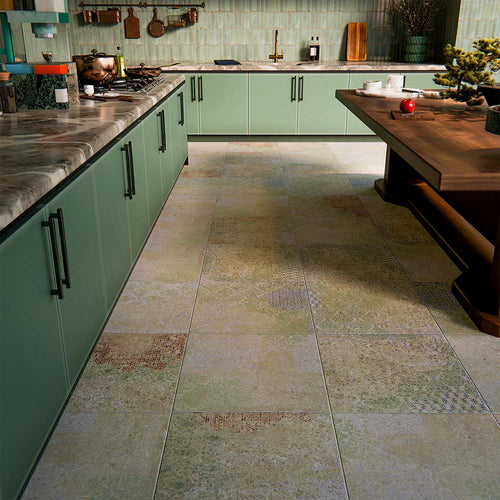 Boho Ocean Blend 60x60cm patterned porcelain floor tiles styled in a contemporary green kitchen setting. The large-format design features a subtle, multi-tonal decorative pattern that blends soft sage, muted blue and warm neutral tones, adding gentle movement underfoot without overpowering the space. Paired with sage cabinetry, warm wood accents and brass details, the patterned floor creates a cohesive, design-led finish ideal for modern kitchen interiors.
