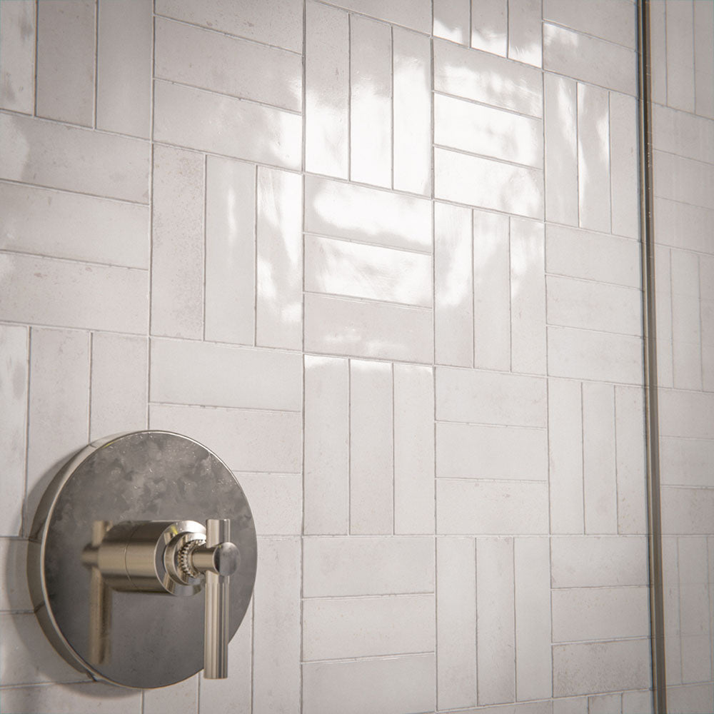 Bathroom interior featuring Foundry Bricks Chalk White 6.5x20cm wall tiles, laid in a structured patterned layout across shower walls, paired with marble effect floor tiles and a green marble vanity for a refined, design-led finish.