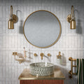 Bathroom featuring Amalfi Brick Carrara Vintage Marble 5.4x22cm wall and floor tiles, installed in a brick layout, showcasing soft white and grey tones, paired with brass fittings, textured details, and a refined, classic contemporary finish.