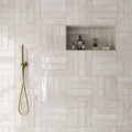 Shower area featuring Nomad Oatmeal brick wall tiles in a 6 × 24.6cm format, laid in a staggered pattern to create a warm, industrial-inspired look.
