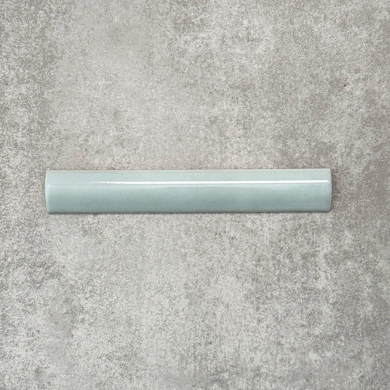 Zellige Aqua 3×20cm Moroccan-style ceramic bullnose tile, showcasing the rounded edge profile, glossy blue-green glaze and subtle tonal variation on a neutral background.